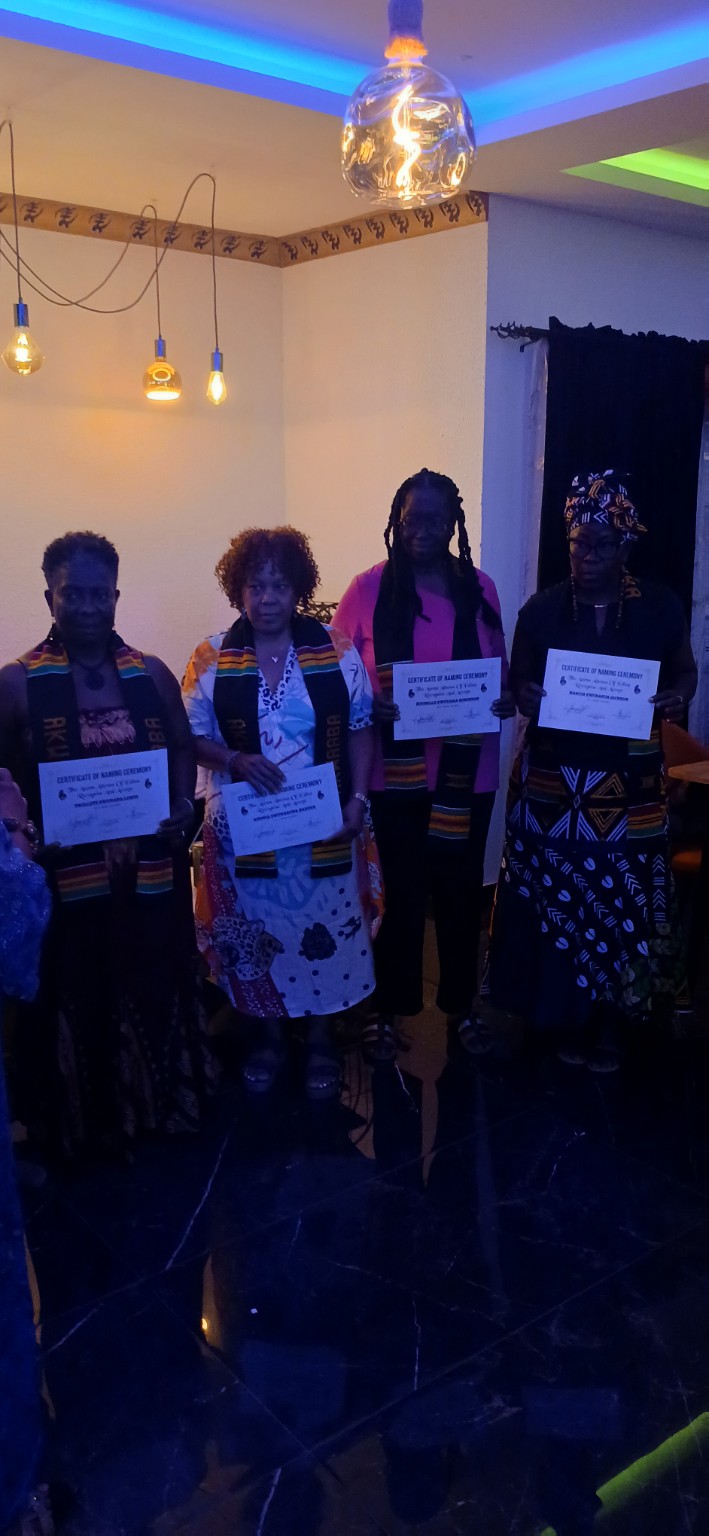 Travellers holding naming ceremony certificates during the October 2025 trip